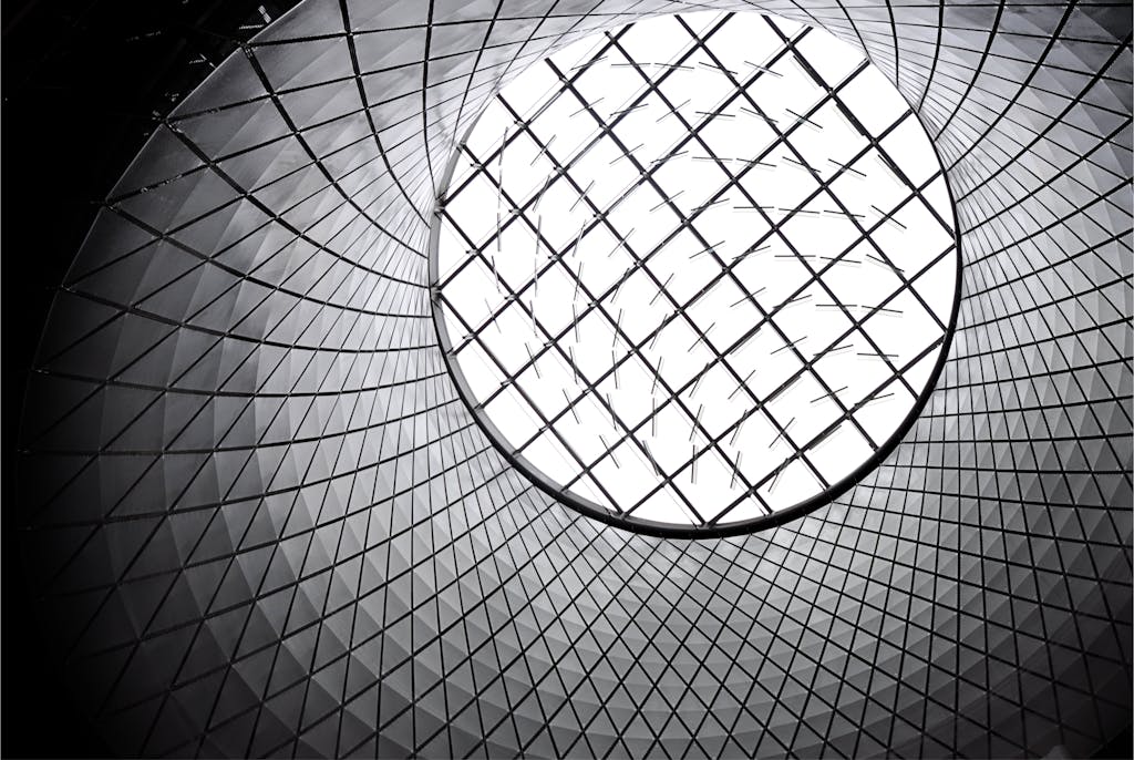 Worm's eye view of a futuristic geometric skylight showcasing modern architecture.